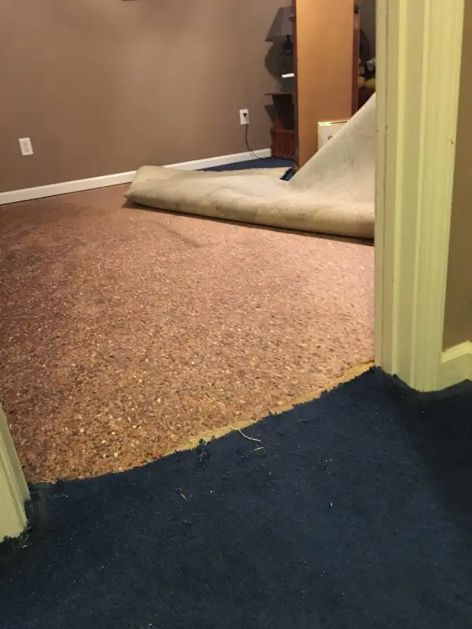 Carpet pad removal revealing water damage during Water Mitigation Services in Colville